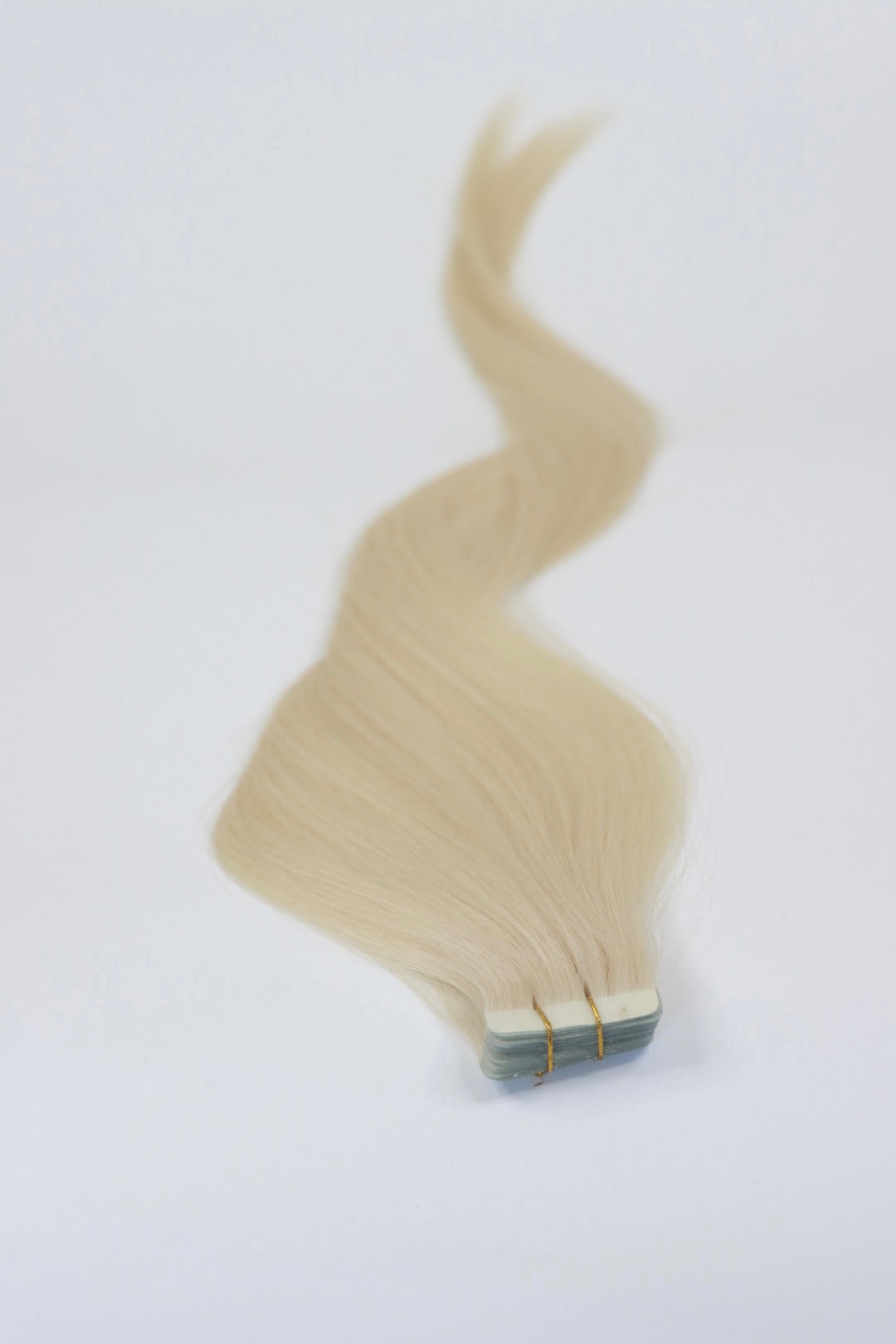 26 Inch tape in hair extensions with a white background